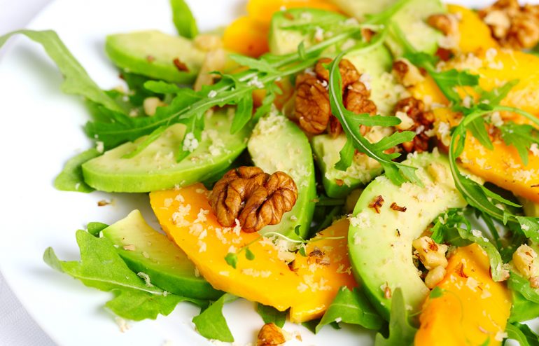 Salad with mango, avocado, arugula and walnuts